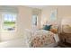 Cozy bedroom with a patterned bedspread, and natural light creating a warm and inviting atmosphere at 22 Jacobs Farm Ln # 11, Lawrenceville, GA 30045
