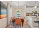 Elegant dining area next to a modern kitchen with hardwood floors and natural light at 22 Jacobs Farm Ln # 11, Lawrenceville, GA 30045
