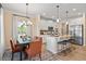 Bright dining area with a modern kitchen featuring an island and stainless steel appliances at 22 Jacobs Farm Ln # 11, Lawrenceville, GA 30045