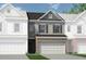 Charming two-story townhome with a two-car garage and a mix of brick and gray siding at 22 Jacobs Farm Ln # 11, Lawrenceville, GA 30045
