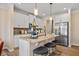 Modern kitchen featuring an island with granite countertop, stainless steel appliances, and stylish pendant lighting at 22 Jacobs Farm Ln # 11, Lawrenceville, GA 30045