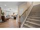 Open-concept living space with staircase, showcasing a view of the living room, dining area, and kitchen at 22 Jacobs Farm Ln # 11, Lawrenceville, GA 30045