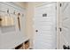 Functional mudroom area with coat hooks, bench seating, storage baskets, and access to agent office at 22 Jacobs Farm Ln # 11, Lawrenceville, GA 30045