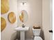 Modern powder room featuring a pedestal sink, round mirror, contemporary lighting and decorative accents at 22 Jacobs Farm Ln # 11, Lawrenceville, GA 30045