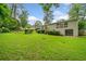Expansive backyard with lush green lawn, mature trees, and a charming patio area perfect for outdoor entertaining at 3222 Edgemont Way, Decatur, GA 30032