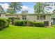 Expansive backyard and exterior of house with white painted brick and lush green lawn at 3222 Edgemont Way, Decatur, GA 30032