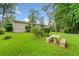 Spacious backyard featuring a stone table and benches, surrounded by lush greenery at 3222 Edgemont Way, Decatur, GA 30032