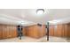 Unfinished basement area with wood paneled walls, support beams and low ceilings at 3222 Edgemont Way, Decatur, GA 30032