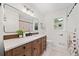 Bathroom featuring a wood vanity with modern black fixtures and neutral decor at 3222 Edgemont Way, Decatur, GA 30032