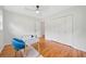 Bedroom with hardwood floors, a ceiling fan, a closet, and a glass top desk with blue chair at 3222 Edgemont Way, Decatur, GA 30032