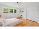 Bright bedroom features a ceiling fan, hardwood floors, built-in desk and shelving, closet, and sunny window at 3222 Edgemont Way, Decatur, GA 30032