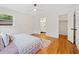 Bright bedroom showcasing hardwood floors and natural light, with an ensuite bathroom at 3222 Edgemont Way, Decatur, GA 30032