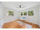 Bedroom features hardwood floors, a ceiling fan, and light-filled windows with views of the lush yard at 3222 Edgemont Way, Decatur, GA 30032