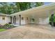 Spacious covered carport featuring brick and post supports leading to a side entrance at 3222 Edgemont Way, Decatur, GA 30032