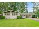 Charming single-story home featuring a brick facade, well-manicured lawn, and a covered carport, nestled in a lush, green landscape at 3222 Edgemont Way, Decatur, GA 30032