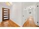 Hallway featuring hardwood floors, white walls, and doors with black hardware at 3222 Edgemont Way, Decatur, GA 30032