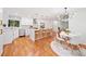 Bright, open kitchen with stainless steel appliances, a central island with seating, and a modern light fixture above the table at 3222 Edgemont Way, Decatur, GA 30032