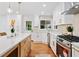Eat-in kitchen featuring white cabinets, stainless appliances, an island with storage, and hardwood floors at 3222 Edgemont Way, Decatur, GA 30032