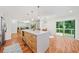 Well-designed kitchen island boasts extra storage and blends seamlessly with an adjacent dining area and hardwood floors at 3222 Edgemont Way, Decatur, GA 30032