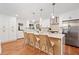 Well-lit kitchen features an island with seating, stainless steel appliances, and sleek white cabinetry at 3222 Edgemont Way, Decatur, GA 30032