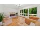 Bright living room featuring hardwood floors, large picture windows and stylish mid-century modern furnishings at 3222 Edgemont Way, Decatur, GA 30032