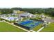 Aerial view of community clubhouse, pool and tennis and pickleball courts surrounded by manicured lawns at 327 Brooke View Trail, Canton, GA 30115