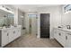 This modern bathroom features double sinks, a glass shower and stylish herringbone floors at 327 Brooke View Trail, Canton, GA 30115