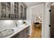 Butler's pantry with gray cabinets and quartz countertops, convenient for storage and entertaining at 327 Brooke View Trail, Canton, GA 30115