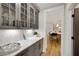 Charming butlers pantry featuring sleek cabinetry, designer hardware and access to the kitchen at 327 Brooke View Trail, Canton, GA 30115