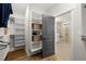 Custom walk-in closet adjacent to the bathroom with built-in shelving and rods at 327 Brooke View Trail, Canton, GA 30115
