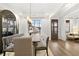 Dining area with ample light, wooden floors and table with gray upholstered benches and chairs at 327 Brooke View Trail, Canton, GA 30115
