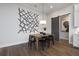 Open dining room with modern chandelier and sliding barn door to kitchen, perfect for Gathering gatherings at 327 Brooke View Trail, Canton, GA 30115