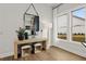 Bright entryway with natural wood console table, stools, and large mirror at 327 Brooke View Trail, Canton, GA 30115