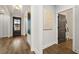 Hallway with hardwood floors, neutral paint, stylish decor, and doorways to other rooms at 327 Brooke View Trail, Canton, GA 30115