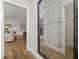 Hallway view showing wood floors, a decorative mirror, and an opening into the living room at 327 Brooke View Trail, Canton, GA 30115
