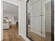 Hallway featuring wood flooring and a decorative wall mirror that reflects the living room at 327 Brooke View Trail, Canton, GA 30115