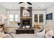 Bright living room with a fireplace, large windows, and cozy seating area at 327 Brooke View Trail, Canton, GA 30115