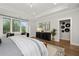 Bright main bedroom featuring tray ceilings, large windows, and access to an ensuite bathroom at 327 Brooke View Trail, Canton, GA 30115