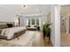 Spacious main bedroom featuring hardwood floors, tray ceiling, and seating area at 327 Brooke View Trail, Canton, GA 30115