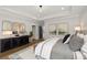 Main bedroom with tray ceiling, stylish decor, and ensuite bathroom access at 327 Brooke View Trail, Canton, GA 30115