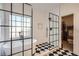 Bright bathroom featuring a freestanding tub, black-framed glass shower, and black and white checkered flooring at 3619 Elinburg Ne Ct, Buford, GA 30519