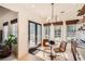 Bright breakfast nook with a double doors, large windows and modern chandelier at 3619 Elinburg Ne Ct, Buford, GA 30519