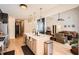 Open concept kitchen with stainless steel appliances and modern fixtures overlooking living room at 3619 Elinburg Ne Ct, Buford, GA 30519