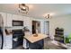 Charming kitchen with black appliances, a butcher block island, recessed lighting, and concrete floors at 3619 Elinburg Ne Ct, Buford, GA 30519