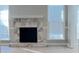 Living room featuring a stone fireplace, with neutral walls, and bright windows at 4465 Kent Rd, Atlanta, GA 30337
