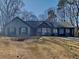 Charming single-story home with a well-maintained front yard, featuring mature trees and a lovely, classic facade at 4465 Kent Rd, Atlanta, GA 30337