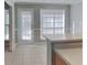 Bright kitchen/dining area with neutral tile flooring and access to the exterior door at 4465 Kent Rd, Atlanta, GA 30337
