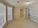 Bright living room featuring neutral tile flooring, fresh paint, and natural light from a bright window at 4465 Kent Rd, Atlanta, GA 30337