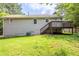 Exterior view of home with a deck and a partially wooded lot at 49 Sweetwater Ct, Powder Springs, GA 30127