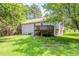 Home exterior showing deck and stairs, with a grassy yard and tree coverage at 49 Sweetwater Ct, Powder Springs, GA 30127